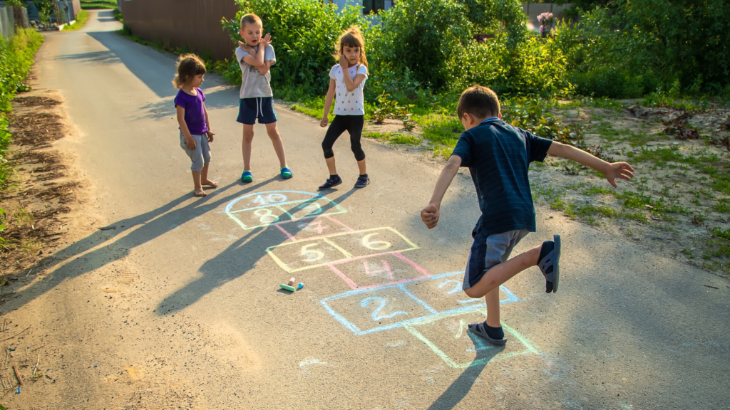 <p>Hopscotch, a classic outdoor game, teaches balance, coordination, and agility as players hop on one foot while navigating a series of squares. Hopscotch also encourages focus and concentration, as players must remember the sequence of squares and avoid stepping on lines. Adulthood requires skills like multitasking and managing competing priorities. This game teaches us to require balance, coordination, and the ability to focus on the task.</p>