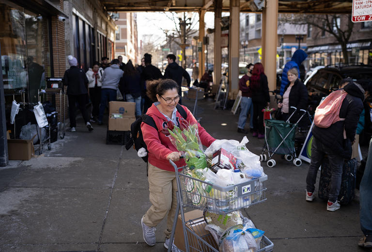 Vincenta Buitrago leaves Nourishing Hope-Sheridan Market with her food items, Monday, Feb. 26, 2024.