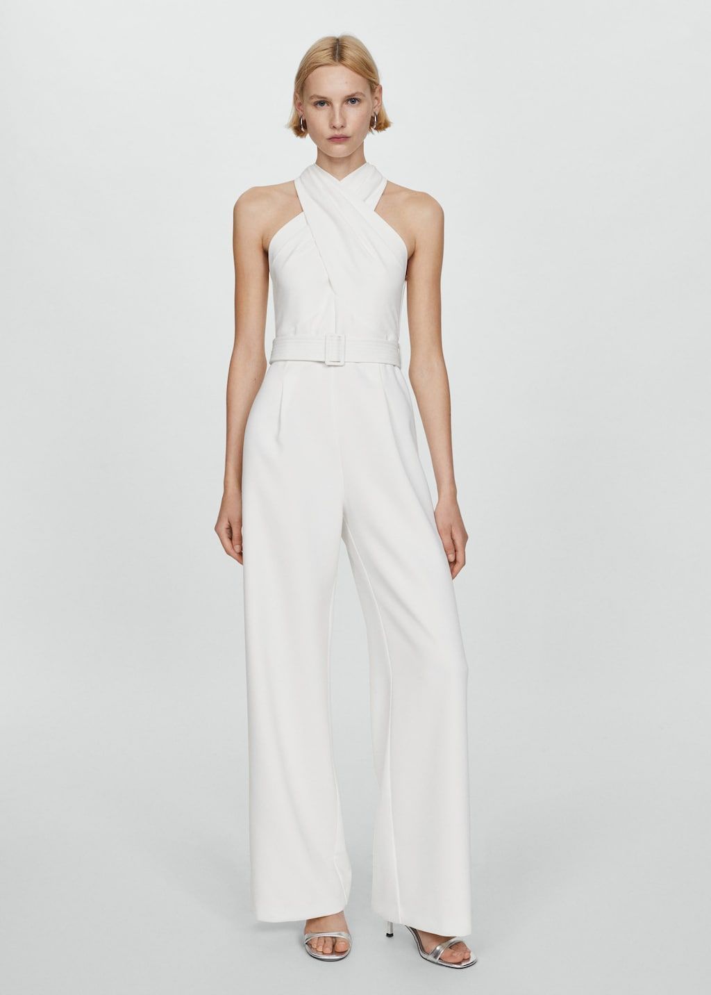 <p><strong>£79.99</strong></p><p><a href="https://shop.mango.com/gb/women/dresses-and-jumpsuits-jumpsuits/belted-crossover-collar-jumpsuit_67056343.html?c=02">Shop Now</a></p><p>Simple yet effective, Mango's wedding jumpsuit is perfect for minimalist brides. We love the halter neckline , flatter belt and, of course, that <a href="https://www.cosmopolitan.com/uk/fashion/style/a43440957/70s-fashion/">'70s-inspired</a> wide-leg silhouette.</p>