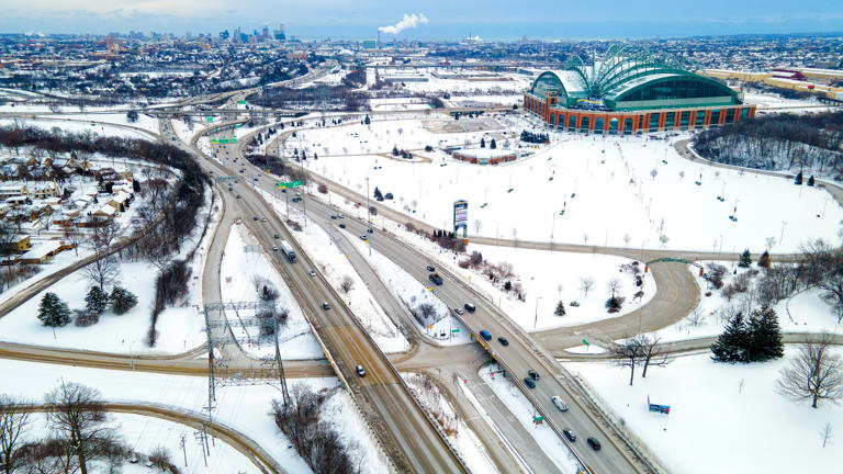 Traffic travels along I-94 over Gen. Mitchell Blvd. and past American Family Field (upper right) in Milwaukee January 30. The U.S. Department of Transportation announced a $1.2 billion spending package to finance the project, which will widen the busy highway from six lanes to eight. The effort may help commuters from more affluent suburbs travel to central Milwaukee and downtown, but it could disrupt life for lower- to middle-class families living in the pathway.