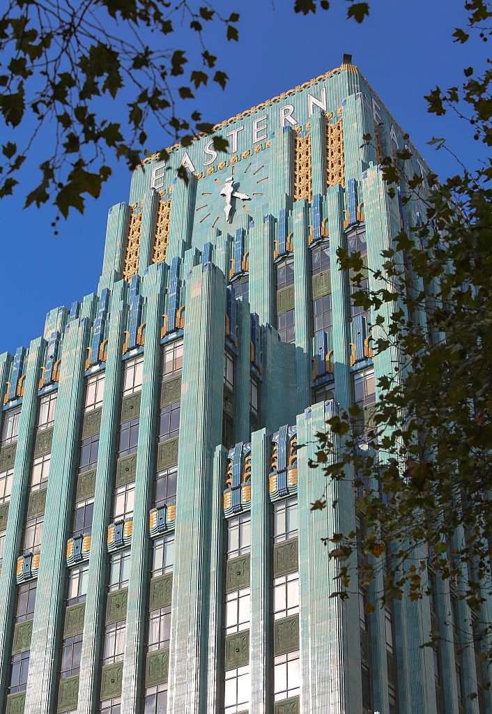 <p>Opened in 1930 after nine months of construction, the <a href="https://www.laconservancy.org/learn/historic-places/eastern-columbia-lofts/">Eastern Columbia Building</a> is an Art Deco gem in downtown Los Angelas. It was the home of the Eastern Outfitting Company and the Columbia Outfitting Company, furniture and clothing stores.</p><p>The building was designed by architect Claud Beelman and its colorful facade is adorned with Art Deco motifs including geometric shapes, zigzags, chevrons and stylized animal and plant forms. The turquoise, blue, and gold terrazzo gives it its gorgeous color.</p>