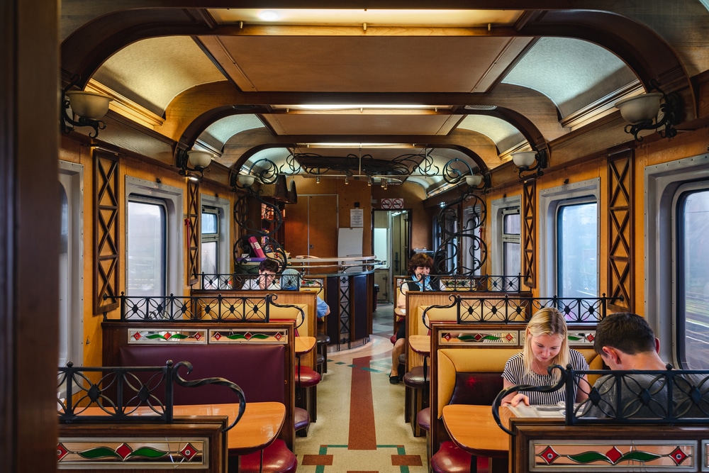 <p>All aboard for a unique culinary journey in a train carriage restaurant! These dining experiences repurpose old train cars into elegant dining spaces, offering a nostalgic trip back to the golden age of train travel. The stationary setting at places like The Grand Bellevue in Switzerland evokes the romance of old-world train journeys, complete with period décor and gourmet meals. It’s a charming way to dine, especially for railway enthusiasts and lovers of vintage charm.</p>