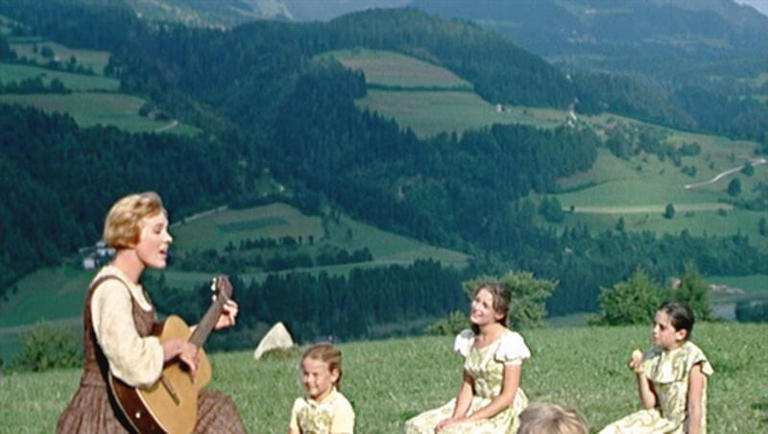 In "The Sound of Music," Julie Andrews (with guitar) as Maria sings for the von Trapp children, from left, Kym Karath as Gretl, Charmian Carr as Liesl, Angela Cartwright as Brigitta and Nicholas Hammond (back to camera) as Friedrich.