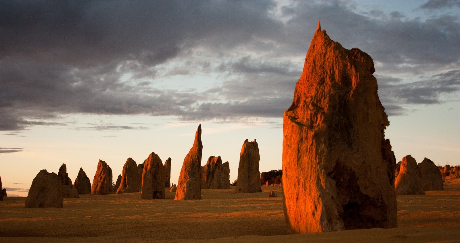<p><span>The Pinnacles in Nambung National Park near Cervantes, Western Australia, are an intriguing natural formation of limestone pillars rising out of the sandy desert. The landscape here is otherworldly, with thousands of these unique structures dotting the landscape.</span></p> <p><span>The Pinnacles are particularly striking at sunrise or sunset when the light casts long shadows and enhances the colors of the formations. The park also offers beautiful beaches and opportunities to spot wildlife, including kangaroos and emus. A visit to the Pinnacles is a journey into one of Australia’s most unusual and photogenic landscapes. </span></p> <p><b>Insider’s Tip: </b><span>Visit during wildflower season (August to October) to see the desert bloom with color. </span></p> <p><b>When to Travel: </b><span>April to October for cooler temperatures and less chance of rain. </span></p> <p><b>How to Get There: </b><span>Drive from Perth to Nambung National Park.</span></p>