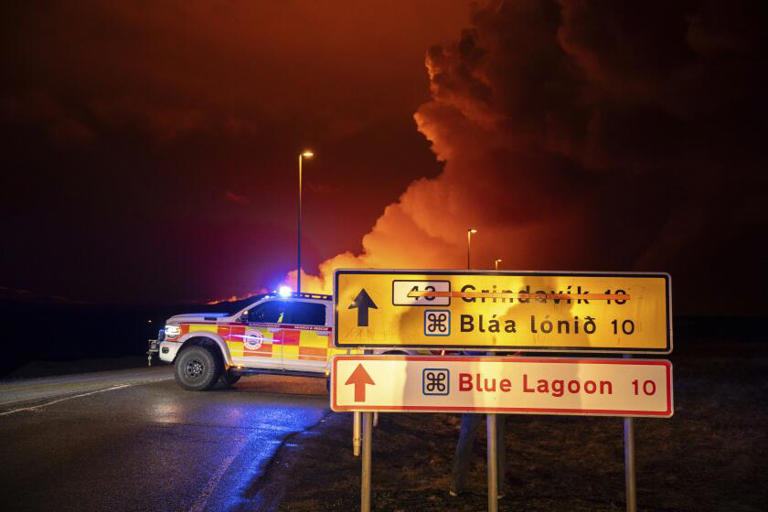 An emergency vehicle is stationed Saturday on a road leading to volcanic activity between Hagafell and Stóri-Skógfell, Iceland. ((Marco di Marco / Associated Press))