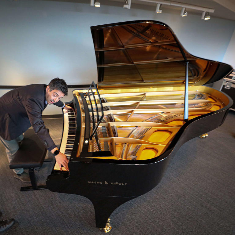 Roman Viñoly, son of famed architect Rafael Viñoly, plays the new Maene Viñoly piano after it was delivered to the Kimmel Center on May 23, 2023.