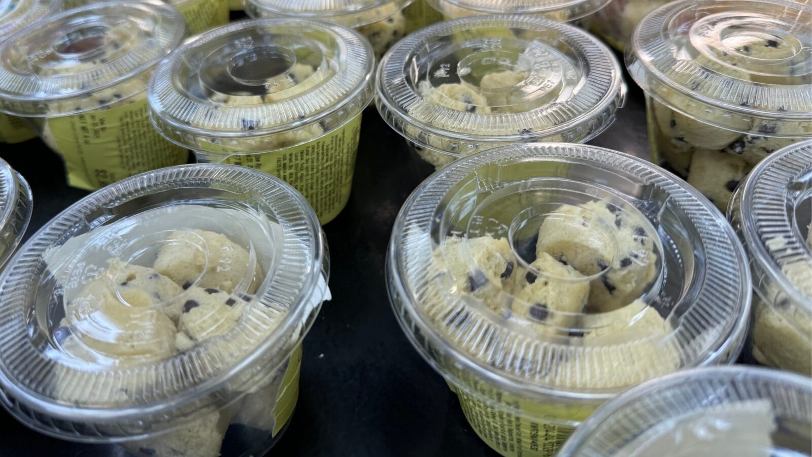 <p>These balls of cookie dough bites are in a clear plastic cup and come in either confetti sugar cookie or chocolate chip varieties. They are sometimes located in the refrigerated islands or in a mini fridge near the fudge counter. </p>