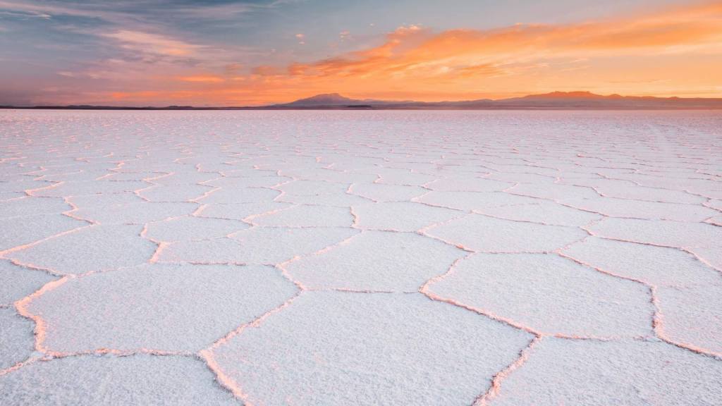 <p>Salt flats are typically breathtaking geological sites, which tells you that visiting the largest salt flat in the world, Salar de Uyuni, would be an unforgettable experience. </p><p>Salar de Uyuni is famous for its vast stretches of bright white salt crust that remained behind after an ancient lake evaporated. </p><p>This is one of the destinations you will love to visit during the rainy season. The rains leave a thin layer of water on the salt crust, creating a mirror-like surface that reflects the sky. As if the scenic salt pan is not enough, the iconic Andes Mountains frame the landscape, creating an even more breathtaking scenery.</p><p class="has-text-align-center has-medium-font-size">Read also: <a href="https://worldwildschooling.com/visa-free-south-american-countries/">South American Destinations To Visit Visa-Free</a></p>