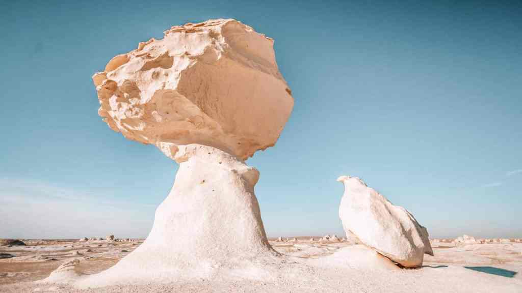<p>With its chalk-white rock formations, White Desert is a photographer’s paradise that keeps attracting tourists. The unique shape of the rock formations makes this landscape even more enticing. The most notable and must-see are the chicken-shaped and giant-mushroom-shaped rock formations standing side by side. </p><p>The White Desert is vast and offers so much to experience. For an immersive experience, take desert safaris, camel rides, or go hiking. You may also consider camping options offered on the ground. Camping is an especially good option for anyone into stargazing, as the desert also offers great stargazing opportunities.</p><p class="has-text-align-center has-medium-font-size">Read also: <a href="https://worldwildschooling.com/visa-free-exotic-locations/">Exotic Places To Visit Visa-Free</a></p>