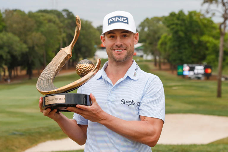 Mar 19, 2023; Palm Harbor, Florida, USA; Tournament winner Taylor Moore celebrates with the champions trophy after winning the Valspar Championship golf tournament. Mandatory Credit: Reinhold Matay-USA TODAY Sports