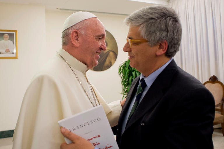 Pope Francis greets Italian journalist Andrea Tornielli at the Vatican