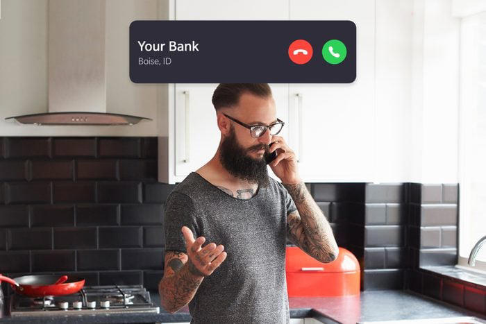 upset man talking on the phone in the kitchen