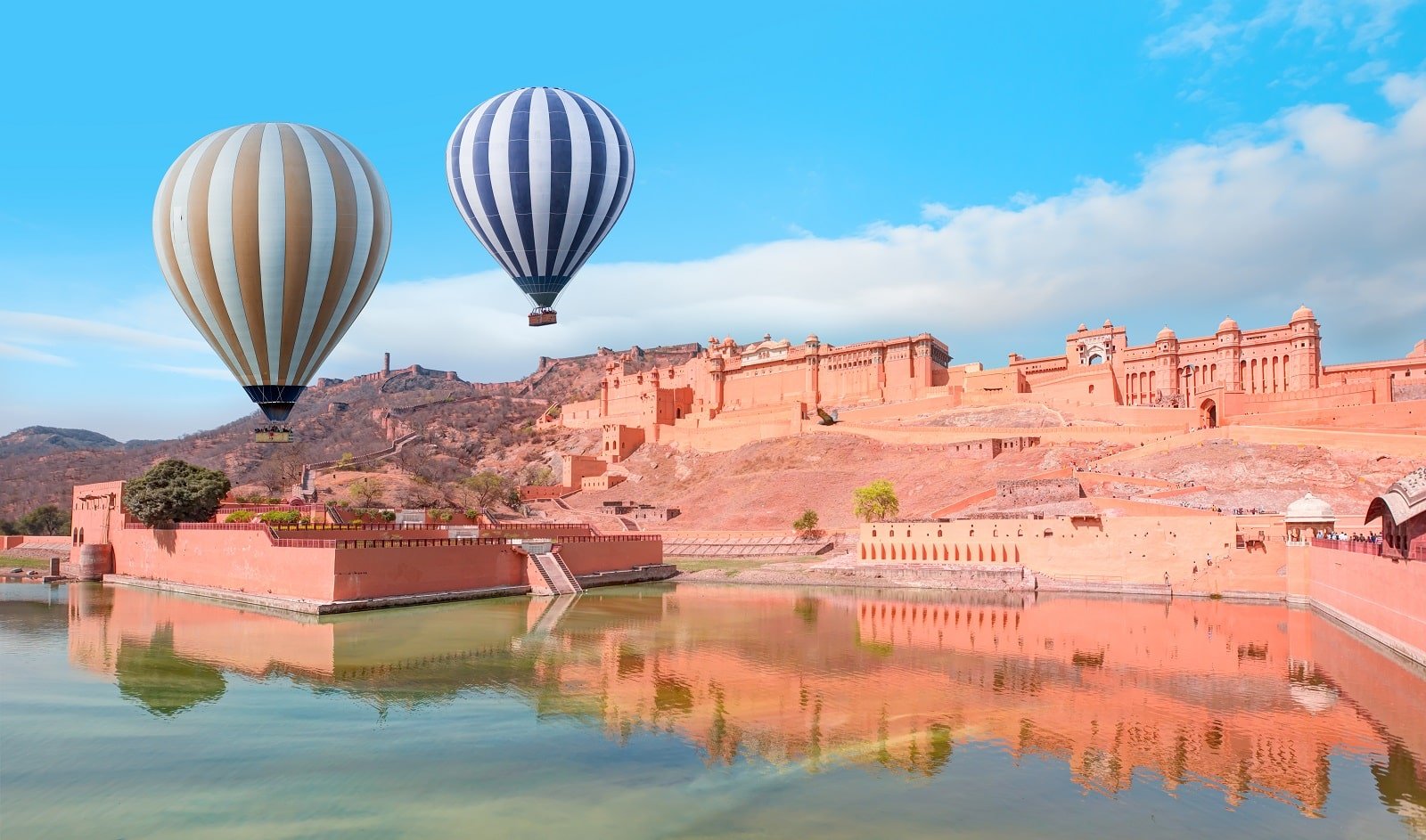 <p><span>Floating over Jaipur in a hot air balloon provides a unique perspective on this vibrant and historic city. The aerial view of majestic forts, palaces, and the sprawling cityscape is a blend of the ancient and the modern. The Amber Fort, with its imposing architecture, is particularly striking from above.</span></p> <p><span>The balloon ride at sunrise offers a tranquil experience, with the early light casting a soft glow over the city’s landmarks. This journey is not just about the views but also about experiencing the rich cultural tapestry of one of India’s most iconic cities.</span></p> <p><b>Insider’s Tip: </b><span>Combine your balloon ride with a visit to the Amber Fort for a full day of exploration. </span></p> <p><b>How to Get There: </b><span>Jaipur is well-connected by air and rail with major cities in India. Balloon tours typically depart from the outskirts of the city. </span></p> <p><b>When to Travel: </b><span>October to March, when the weather is cooler and more pleasant.</span></p>