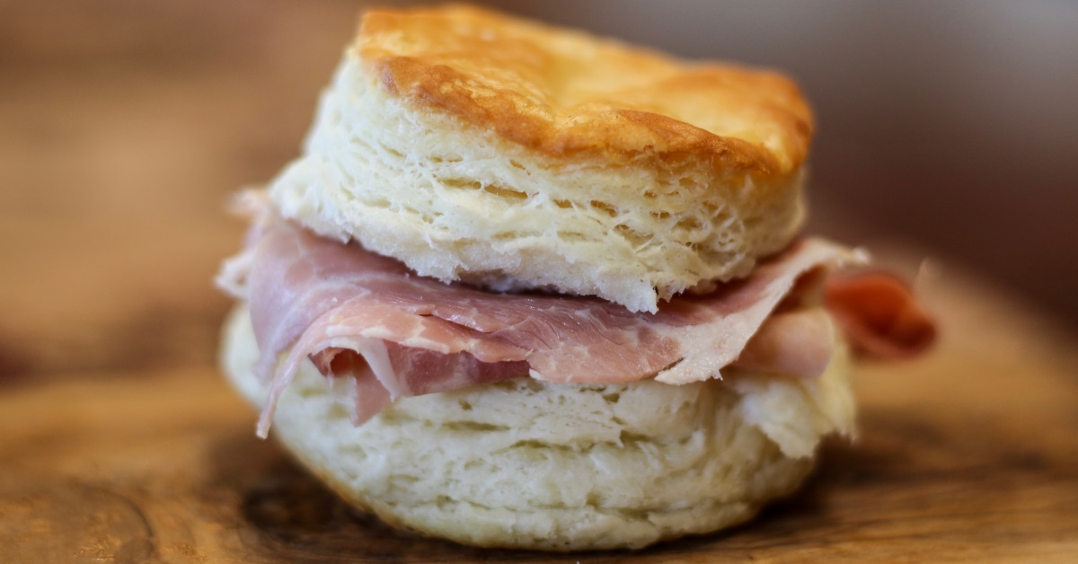 <p> At Tudor’s Biscuit World, you can step up to the counter to order from a large menu of breakfast, lunch, and dinner choices. The stacked ham sandwich is just one of several must-try options. </p> <p> For breakfast, nothing beats a biscuit sandwich prepared with what you love on it. </p>