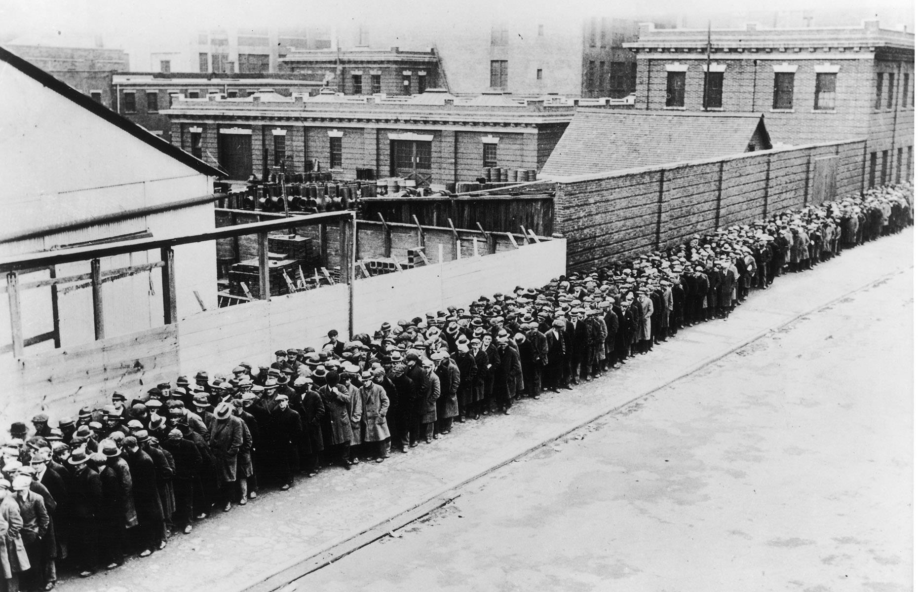 <p>As workers tumbled into poverty thanks to rapidly rising unemployment and, in some cases, the total loss of their savings, they were forced to rely on the state for help. Local government initiatives to feed and shelter those in need were overwhelmed by crowds of people, like this long queue of men patiently waiting for a free dinner at a municipal boarding house in New York.</p>
