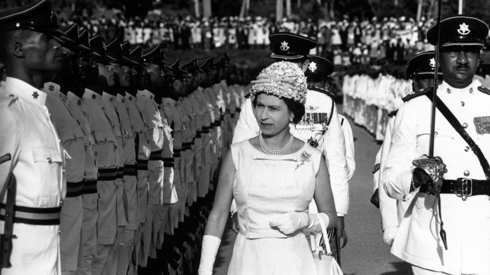 <p>                     On a royal tour of the Caribbean in 1996, the Queen inspected a guard of honour at the Teteron Barracks in Trinidad, a military base that formed part of Trinidad and Tobago’s Defence Force.                   </p>                                      <p>                     The image is strikingly similar to many taken in the UK. The Queen would often inspect UK military troops during important milestones, such as the annual Trooping the Colour celebrations.                   </p>                                      <p>                     The Queen’s visit to Trinidad & Tobago formed part of a larger, and very busy, Caribbean tour, in which she and the Duke of Edinburgh stopped in Saint Kitts & Nevis, the Bahamas, Antigua, Barbados, Jamaica, Grenada, Saint Lucia, Montserrat, and many more.                   </p>