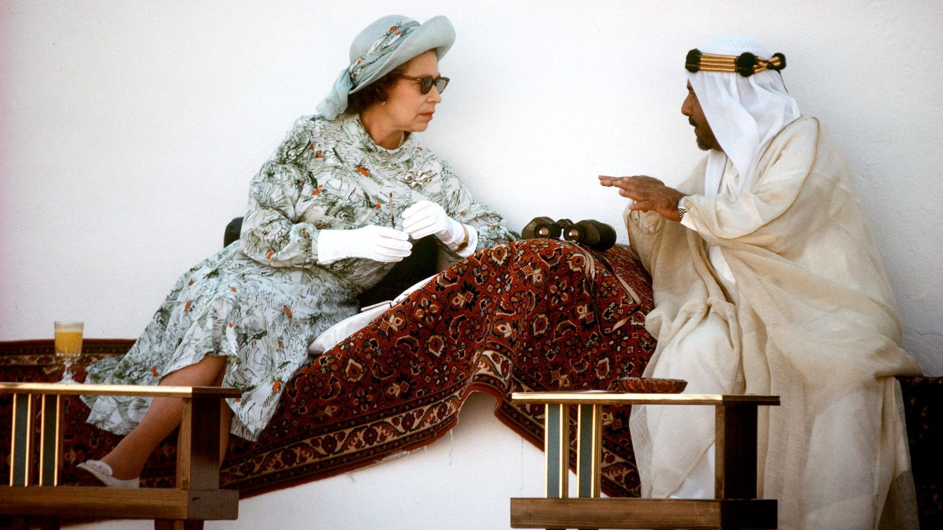 <p>                     A brilliant image of Queen Elizabeth on one of her countless royal tours is when she was captured looking relaxed whilst leaning across a chair to talk to the Emir of Bahrain at the time, Isa bin Salman bin Hamad Al Khalifa, whilst the pair were taking in a day of horse racing and camel racing. The picture was taken during Elizabeth and Philip’s tour of the Gulf between February and March of 1979.                   </p>                                      <p>                     The image shows the monarch looking informal and engrossed in her conversation; a somewhat unusual picture of the Queen, as she was often seen in more formal positions, be it sat upright at a state dinner, or stating up for an audience with a Prime Minister.                   </p>
