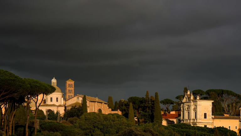 The San Gregorio al Celio church, right, and the St. John and Paul Basilica are illuminated by the sunset light, in Rome, Thursday, Feb. 29, 2024.