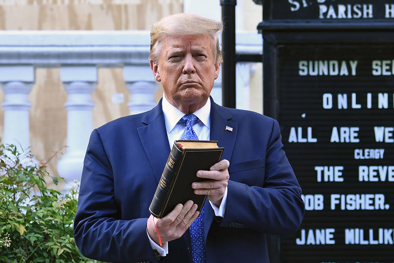 Donald Trump holds up a Bible outside of St John's Episcopal church across Lafayette Park in Washington, DC on June 1, 2020. The former president has sparked the ire of Christians for selling Bibles for $59.99 ahead of Easter.