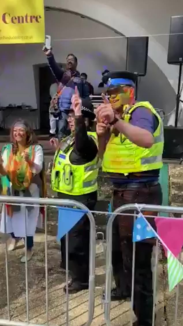 'dancing while my nan's house was being burgled': police face backlash after officers covered in coloured paint bust moves at town's holi festival