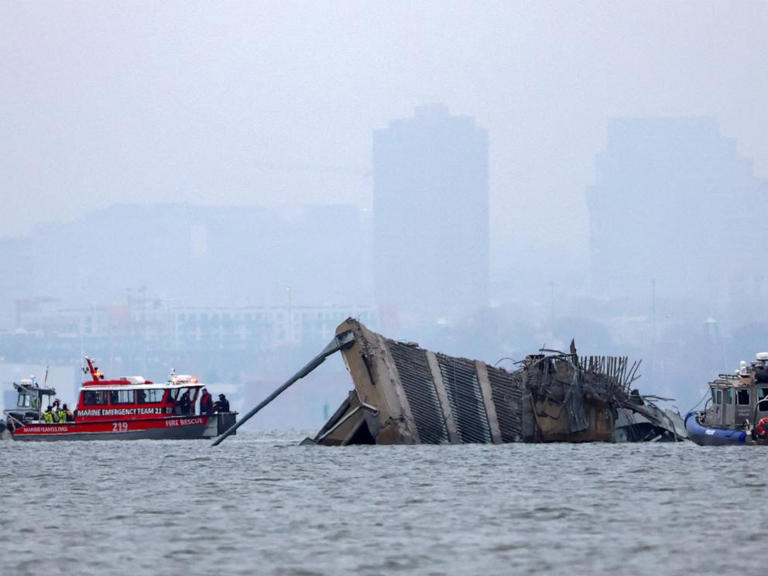 An emergency marine boat with divers and a police boat work near the collapsed section of the Francis Scott Key Bridge on March 27, 2024 after the Dali cargo vessel crashed into it, in Baltimore yesterday.