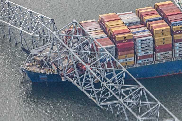 Segments of the collapsed Francis Scott Key Bridge rest on the container ship Dali in Baltimore on March 26, 2024.