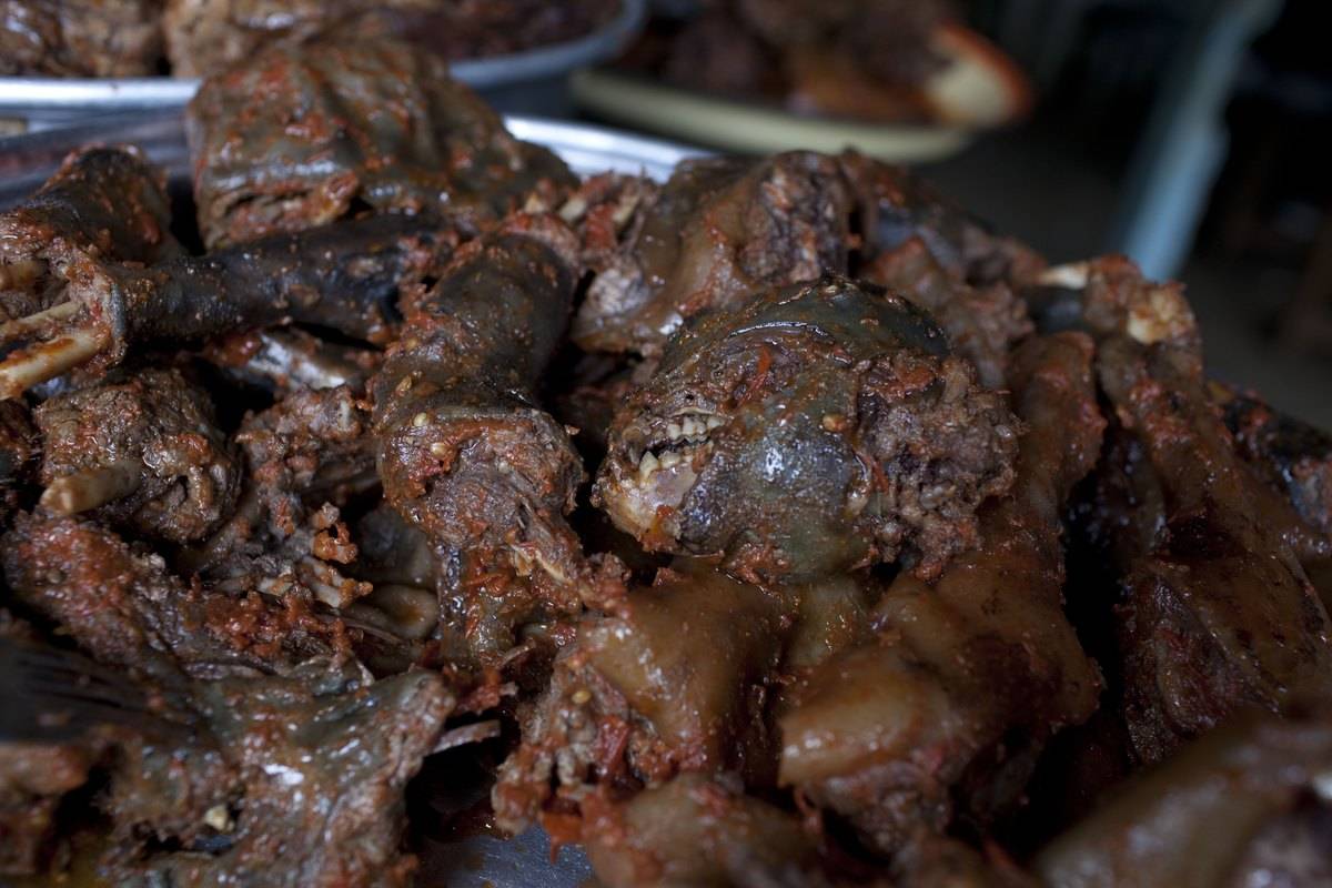 <p>Bushmeat is hunting and selling wild animals for food. Depending on the country, these may include bats, monkeys, or squirrels. Not only is this illegal in some areas, but it's also dangerous. According to the UN, bushmeat may spread tuberculosis, ebola, yellow fever, and other fatal diseases.</p> <p>The CDC adds that bushmeat is not regulated. Because it is illegal in many areas, the vendors may not adhere to food safety regulations. It may seem "exotic," but avoid bushmeat at all costs. Some people have died from bushmeat-related diseases.</p>