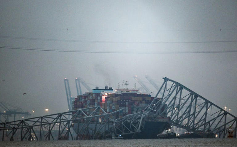 The collapsed Francis Scott Key Bridge lies on top of the container ship Dali in Baltimore, Maryland, on March 27, 2024. Authorities in Baltimore were set to focus on expanding recovery efforts on March 27 after the cargo ship slammed into the bridge, causing it to collapse and leaving six people presumed dead. All six were members of a construction crew repairing potholes on the bridge when the structure fell into the Patapsco River at around 1:30 am (0530 GMT) on March 26. 