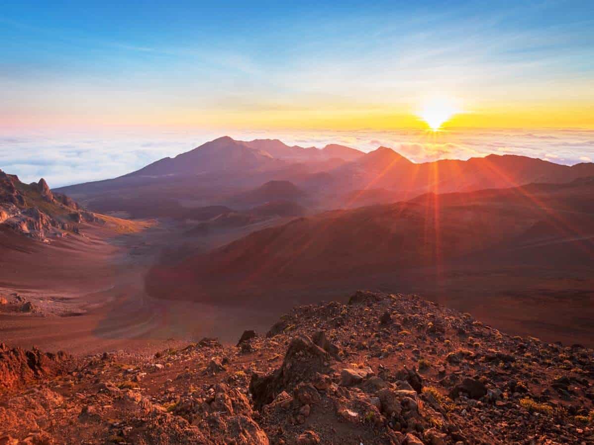 <p>Head to the famed island of Maui for a bucket list-worthy sunrise. With an absurdly early wakeup call, you can make your way up to Maui’s tallest peak, Haleakala, which translates to “the House of the Rising Sun.” No wonder it’s a <a href="https://www.nps.gov/hale/planyourvisit/sunrise.htm" rel="nofollow noopener">great sunrise spot.</a></p><p>When the sun starts to crest over the horizon, the sky will be painted in dizzying colors of pastel pink, bright orange, and warm gold. You might even get some tinges of purple and indigo in the mix, too. Simply put, it’s absolutely magical.</p><p>You have to visit <a href="https://thehappinessfxn.com/haleakala-national-park/">Haleakala National Park.</a></p>