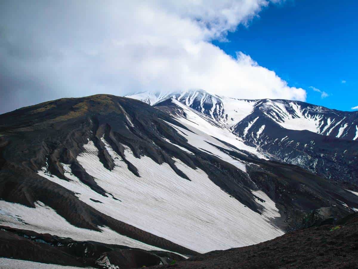 <p>You might be thinking, “Snow? In Hawaii?”</p><p>Yes, believe it or not, we get snow in Hawaii, but only on the tallest mountain peaks.</p><p>The Big Island’s Mauna Kea is the most common place to find snow on the islands. And it’s no wonder why – when measured from the seafloor to the peak, Mauna Kea is the tallest mountain in the world, even beating Mount Everest!</p><p>But seeing snow on Mauna Kea is a little more complicated than it seems. Most rental car companies won’t let you drive up to the peak. Your best bet is to take a dedicated Mauna Kea summit tour and cross your fingers for some island snow.</p>