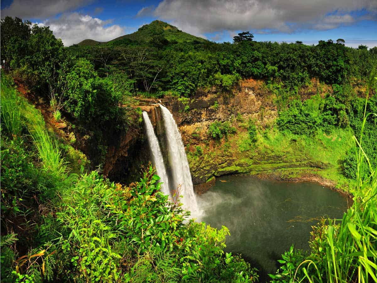 <p>Even though Hawaii is known for its sunny skies, the island of Kauai is surprisingly rainy. In fact, the Garden Isle is home to one of the rainiest spots in the world, Mt. Waialeale.</p><p>While that might be a bummer to some, waterfall chasers will be on cloud nine. After all, with rain comes a whole lot of waterfalls. Some of Kauai’s best cascades include Wailua Falls, Manawaiopuna Falls, Waipoo Falls, and Secret Falls (also known as Uluwehi Falls—and it’s not much of a secret).</p>