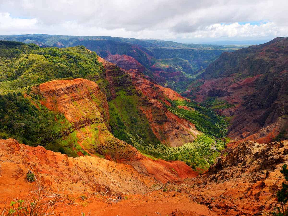 <p>Head to the island of Kauai and explore Waimea Canyon – also known as the “Grand Canyon of the Pacific.”</p><p>There are a few different ways to explore this picturesque canyon. You can drive up to the scenic viewpoints if you want to keep things nice and easy. If you want to challenge yourself, you can tackle one of the spectacular hikes – I recommend the Waipoo Falls Trail for a fun waterfall surprise. Or you can take to the skies with an epic Waimea Canyon helicopter tour.</p>