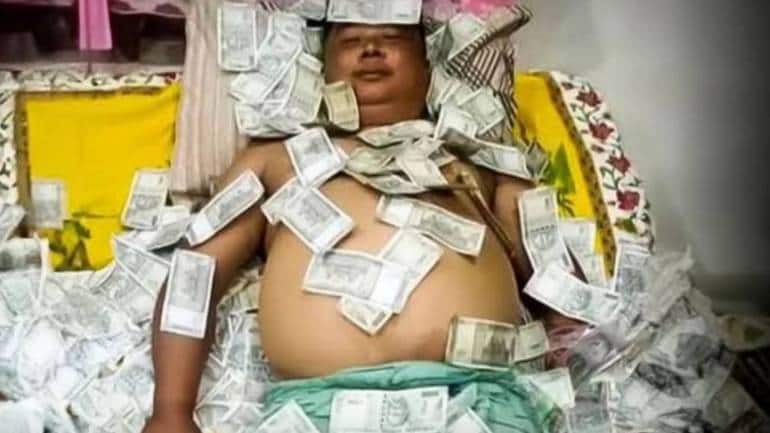 assam politician seen sleeping on pile of rs 500 notes in viral pic