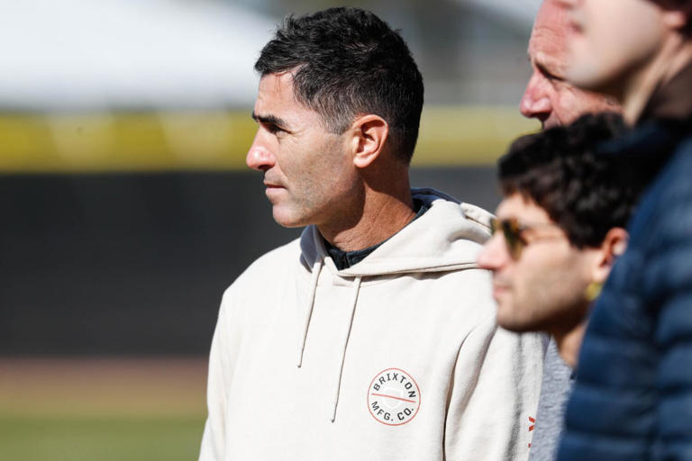 Peoria, AZ - February 16: Padres general manager and president of baseball operations AJ Preller watches players during a spring training practice at Peoria Sports Complex on Thursday, Feb. 16, 2023 in Peoria, AZ.