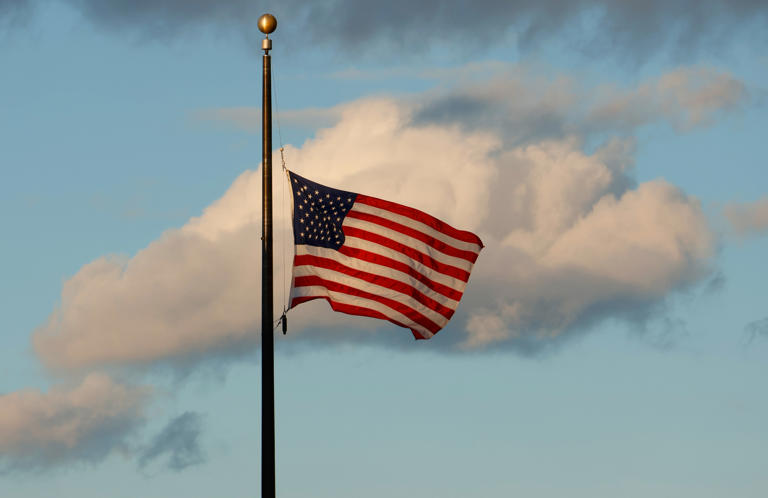 An American flag is seen flying.