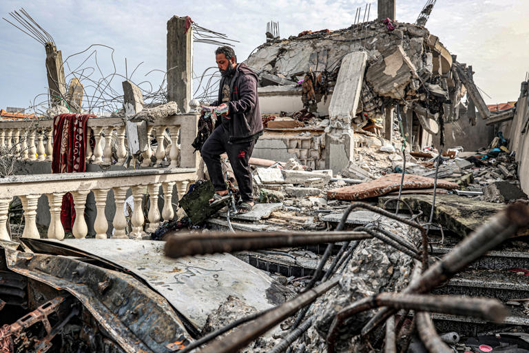 A man is pictured amongst the rubble of a building that was hit by Israeli bombardment in Rafah, in the southern Gaza Strip, on March 26, 2024. The U.S. and others have repeatedly warned Israel against a full-scale ground operation into the border town. SAID KHATIB/AFP via Getty Images