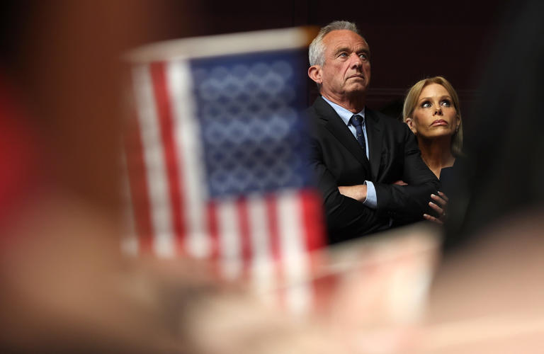 March 26, 2024: Actress Cheryl Hines and her husband, Independent presidential candidate Robert F. Kennedy Jr., look on during a campaign event to announce his pick for a running mate at the Henry J. Kaiser Event Center on March 26, 2024 in Oakland, California. Independent presidential candidate Robert F. Kennedy Jr. announced Silicon Valley attorney Nicole Shanahan as his running mate.