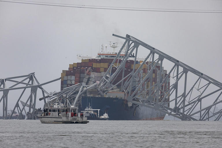 Workers continue to investigate and search for victims after the cargo ship Dali collided with the Francis Scott Key Bridge causing it to collapse yesterday, on March 27, 2024, in Baltimore, Maryland. Two survivors were pulled from the Patapsco River and six missing people are presumed dead after the Coast Guard called off rescue efforts.