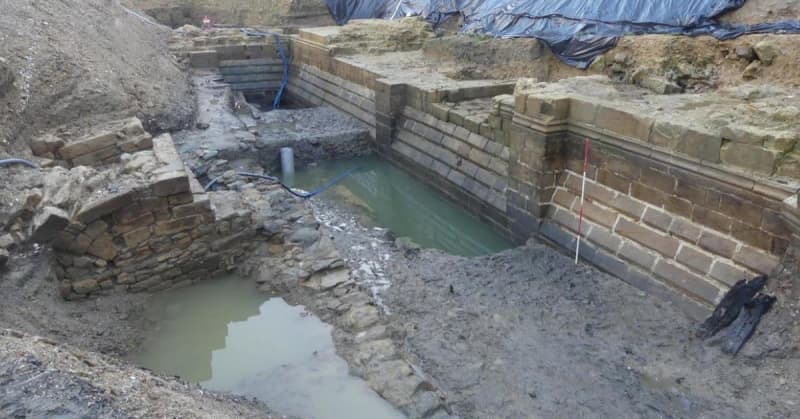 600-year-old castle fortress discovered at french hotel development project, unearthing moat, tower and artifacts