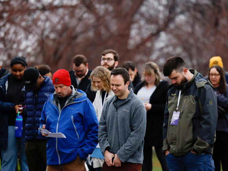 People pray at a vigil for victims of the Francis Scott Key Bridge collapse in Baltimore, March 28, 2024.