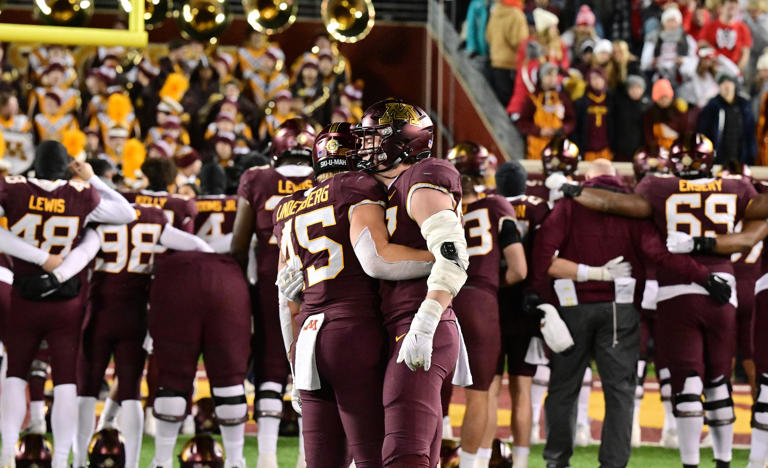 Minnesota Gophers linebacker Cody Lindenberg (45) and Minnesota Gophers defensive lineman Danny Striggow (92) console each other after the Gophers lost to the Badgers 28-14 in a NCAA football game against at Huntington Bank Stadium in Minneapolis on Saturday, Nov. 25, 2023.