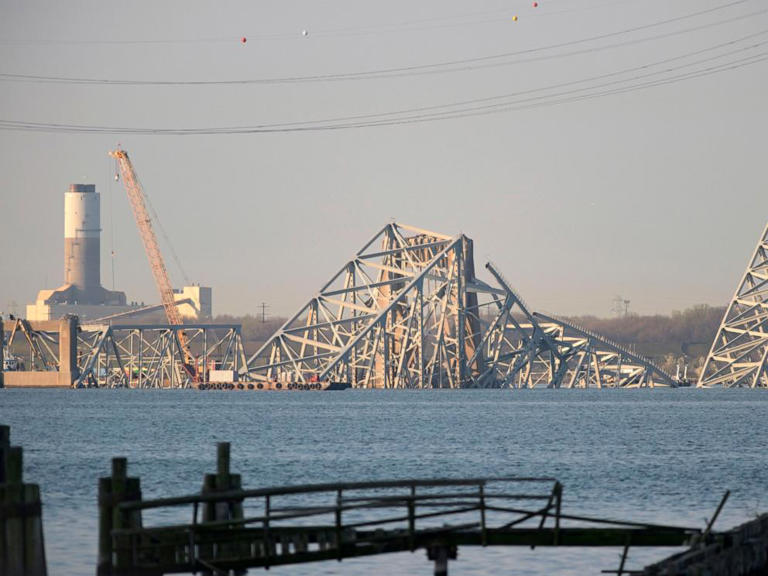 A crane is seen near the wreckage of the Francis Scott Key Bridge on March 29, 2024 in Baltimore.