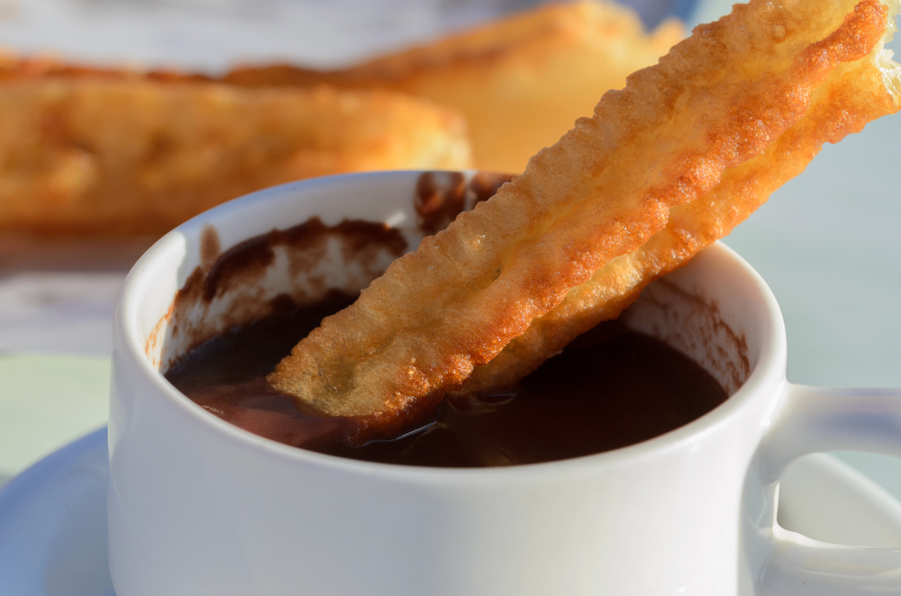 <p>Treat yourself to a Spanish breakfast delight with churros con chocolate, featuring crispy fried dough dipped in rich, thick hot chocolate. Whether enjoyed as a sweet indulgence or a comforting morning treat, this combination is sure to satisfy your cravings. Average Pricing: $3 – $6.</p>