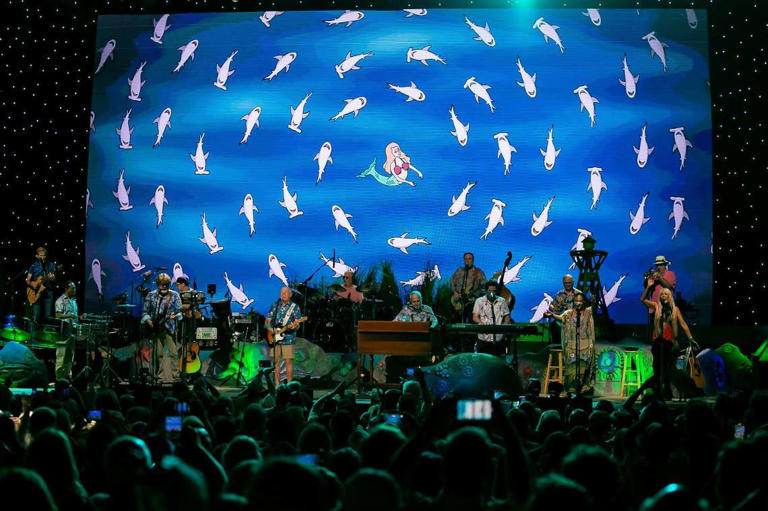 Jimmy Buffett and his Coral Reefer Band perform Fins during their concert at the iTHINK Financial Amphitheatre in West Palm Beach, Florida on Thursday, December 9, 2021. A team of scientists from the University of Miami Rosenstiel School named a new species of a member of a group of crustaceans, gnathiid isopods, the Gnathia jimmybuffetti after the singer-songwriter.