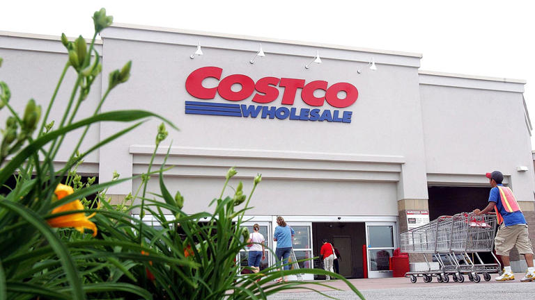 A worker pushes carts outside a Costco Wholesale store May 31, 2006, in Mount Prospect, Ill. Getty Images