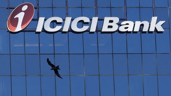 ICICI Bank Credit Card rules: A bird flies past the facade of the ICICI bank head office in Mumbai, India. ICICI Bank will implement changes to airport lounge access benefits for 21 credit cards from April 1.