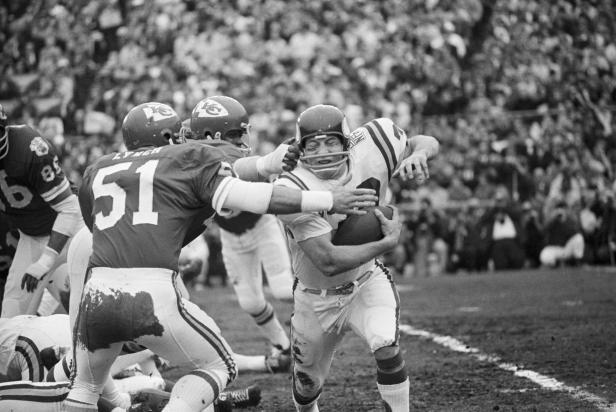 (Original Caption) NEW ORLEANS-1/11/70-: Minnesota Vikings fullback Bill Brown (30), picks up yardage in first quarter of Super Bowl before being stopped by Kansas City linebacker Jim Lynch (51).