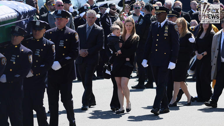 Widow Stephanie Diller and son Ryan are seen at the funeral service for New York City Police Department Officer Jonathan Diller was held at Saint Rose of Lima Roman Catholic Church in Massapequa Park, N.Y., on Saturday, March 30, 2024. Diller was fatally shot on Monday during a traffic stop in Queens after a man with 21 prior arrests allegedly shot him in the stomach.