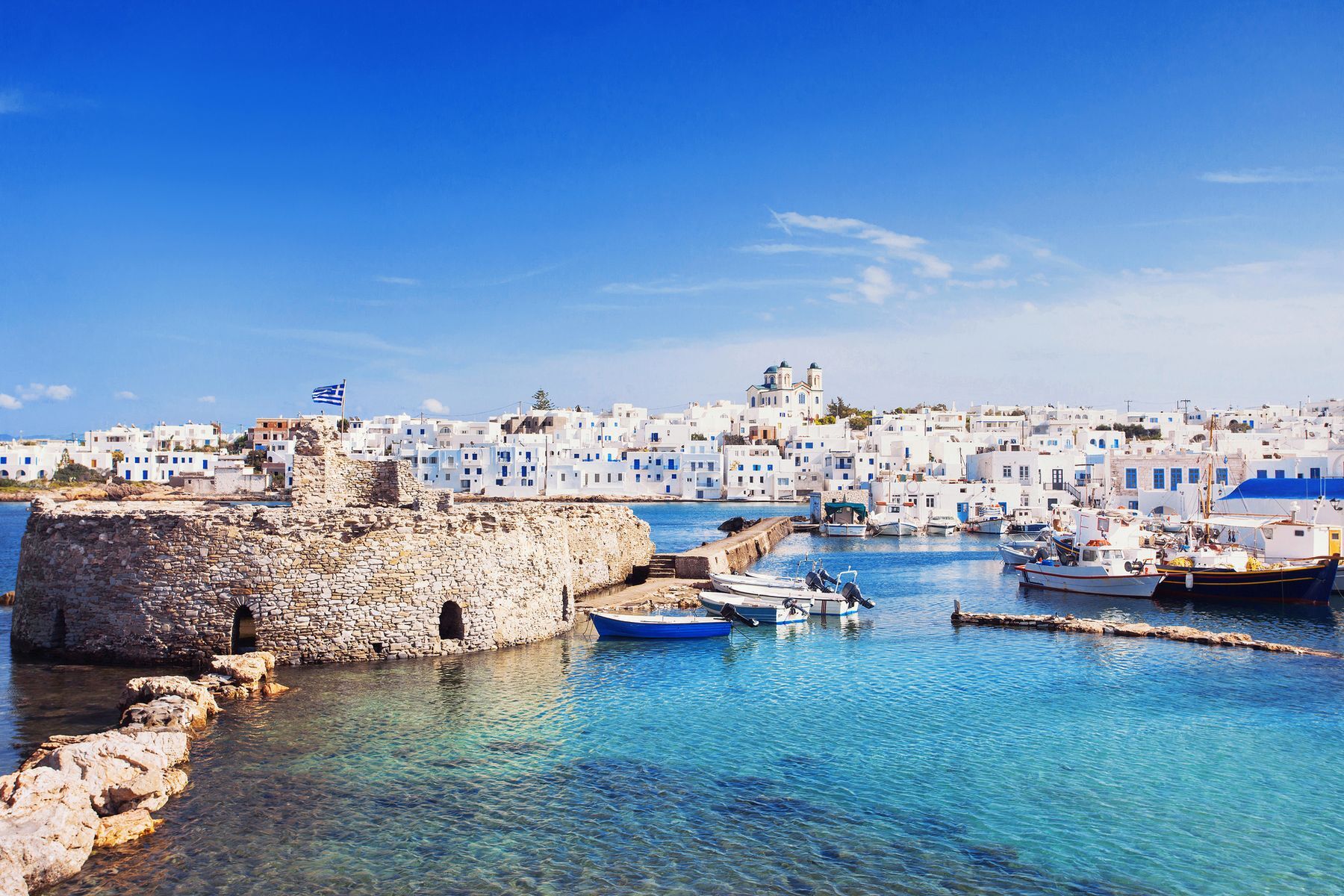 With picturesque villages and pristine beaches, the classically Greek <a href="https://www.discovergreece.com/cyclades/paros" rel="noreferrer noopener">Paros</a> tends to be less crowded and less expensive than other <a href="https://www.visitgreece.gr/islands/cyclades/" rel="noreferrer noopener">Cyclades</a> islands, yet offers just as much to see and do. Stop by <a href="https://naoussaparos.com/" rel="noreferrer noopener">Naoussa</a> to ramble through the winding streets of its Venetian port, then head to Parikia to visit its <a href="https://archaeologicalmuseums.gr/en/museum/5df34af3deca5e2d79e8c198/archaeological-museum-of-paros" rel="noreferrer noopener">archaeological museum</a>, filled with the splendour of ancient Greece. For a bit of relaxation, check out the wind-sculpted rocks at Kolymbithres <a href="https://www.discovergreece.com/travel-ideas/best-of/12-best-beaches-paros" rel="noreferrer noopener">Beach</a>, while water sports enthusiasts will want to make their way to Golden Beach.
