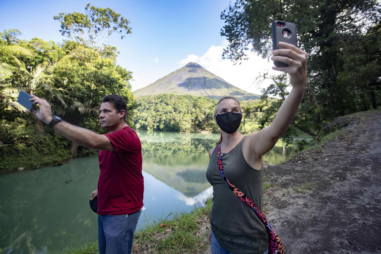 Tourists near the Arenal volcano, north of San Jose, Costa Rica.